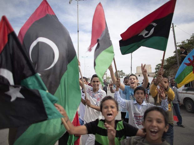 Libyan children waving National Transitional Council flags 