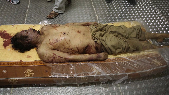 Body of Libyan dictator Muammar Qaddafi lies on mattress in morgue in Misrata, Libya on Oct. 21, 2011  
