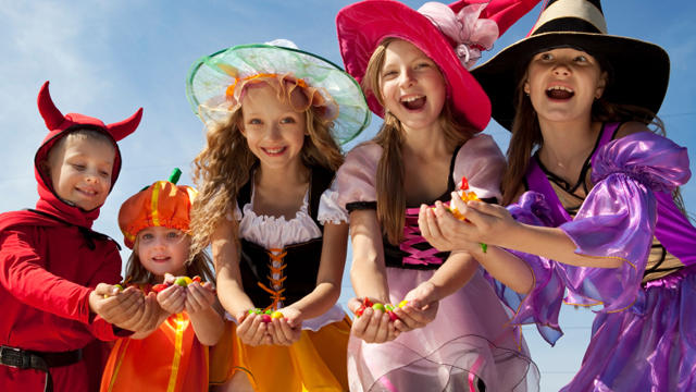 Five Halloween Children Holding Candies 