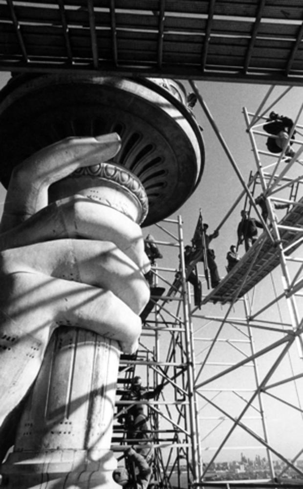 Workers remove scaffolding Dec. 17, 1985, from around the torch of the Statue of Liberty in New York. 