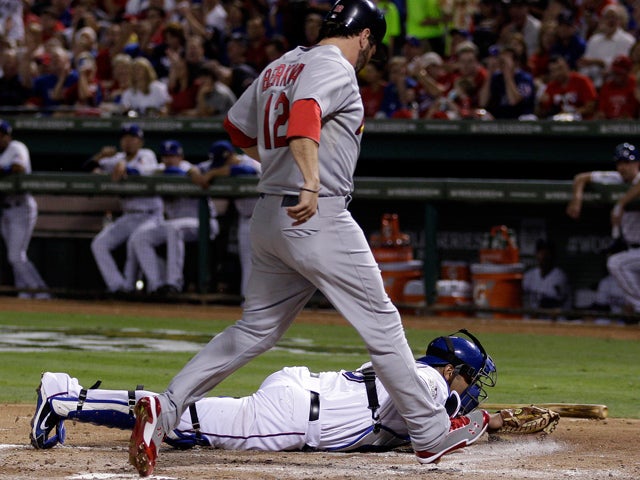 Lance Berkman scores after Rangers catcher Yorvit Torrealba couldn't handle a throw 