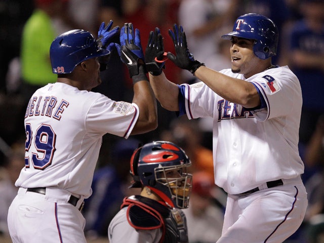 Nelson Cruz is congratulated after hitting a home run 