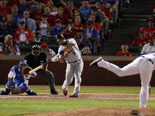 Albert Pujols hits a home run during the ninth inning  
