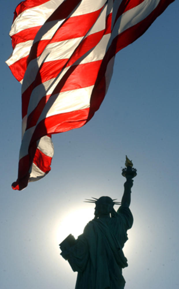 An American flag waves behind the Statue of Liberty on Liberty Island in New York Harbor Dec. 20, 2001, the first day the island was open to the public since the Sept. 11, 2001, terror attacks. The statue itself did not reopen to the public until Aug. 3,  