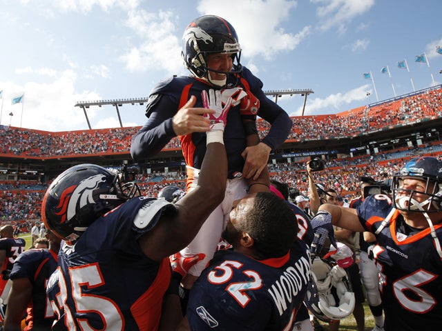 Matt Prater is held up by teammates after kicking the winning field goal 