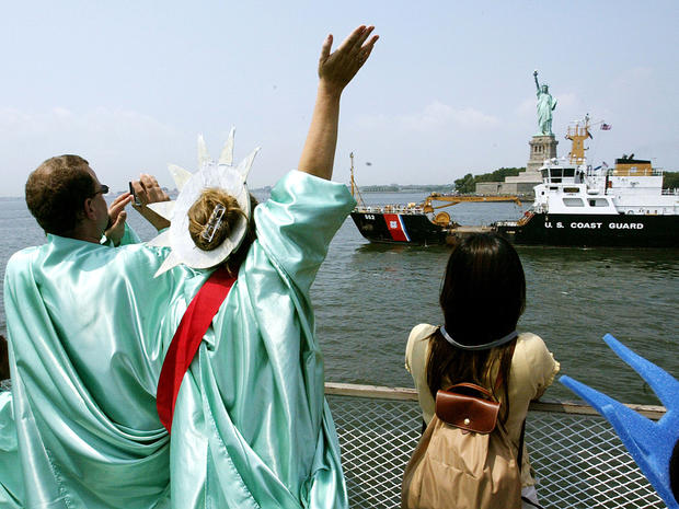 Passengers dressed as Lady Liberty depart on a boat from the Statue of Liberty to Manhattan Aug. 3, 2004, the day the statue's pedestal was opened to the public for the first time since the Sept. 11, 2001, terrorist attacks. The statue's crown requires a  