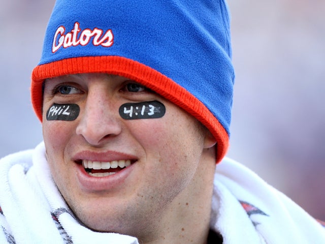 Tim Tebow smiles following a game 