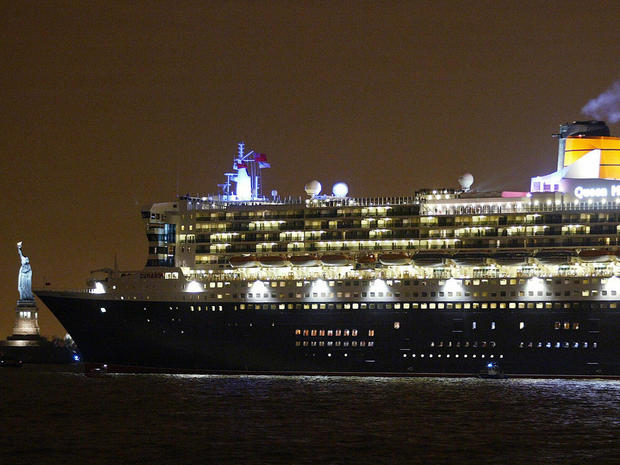 The Queen Mary II, then the largest cruise ship in the world, sails past the Statue of Liberty as she leaves New York City April 25, 2004, for England. 