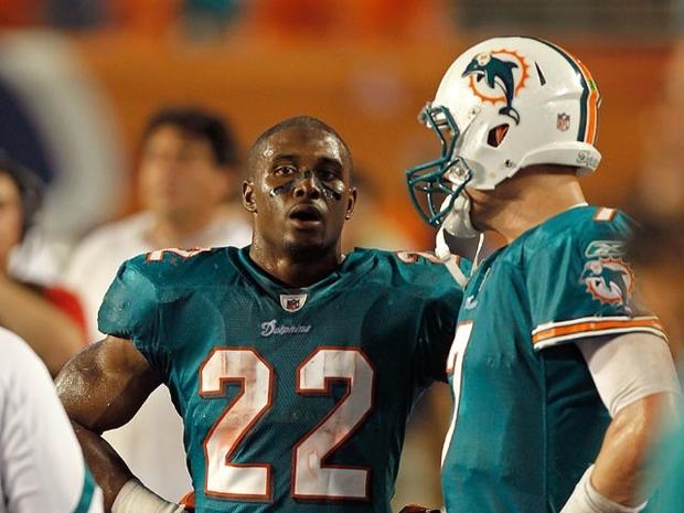 MIAMI GARDENS, FL - SEPTEMBER 12: Reggie Bush #22 and Chad Henne #7 of the Miami Dolphins talk during a game against the New England Patriots at Sun Life Stadium on September 12, 2011 in Miami Gardens, Florida. (Photo by Mike Ehrmann/Getty Images) 