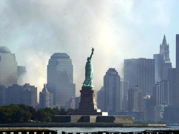 The Statue of Liberty is seen from Jersey City, N.J., as smoke and ash from the destroyed World Trade Center rise over the southern end of Lower Manhattan Sept. 12, 2001. 