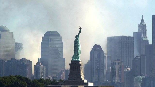 The Statue of Liberty is seen from Jersey City, N.J., as smoke and ash from the destroyed World Trade Center rise over the southern end of Lower Manhattan Sept. 12, 2001. 