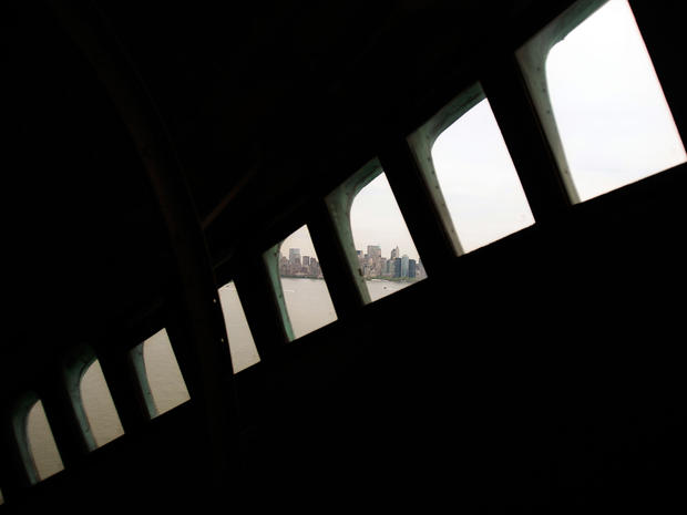 Lower Manhattan is seen through the windows in the crown of the Statue of Liberty May 8, 2009, the day Secretary of the Interior Ken Salazar announced that the crown, closed to the public after the 9/11 attacks, would open again that Fourth of July to a l 