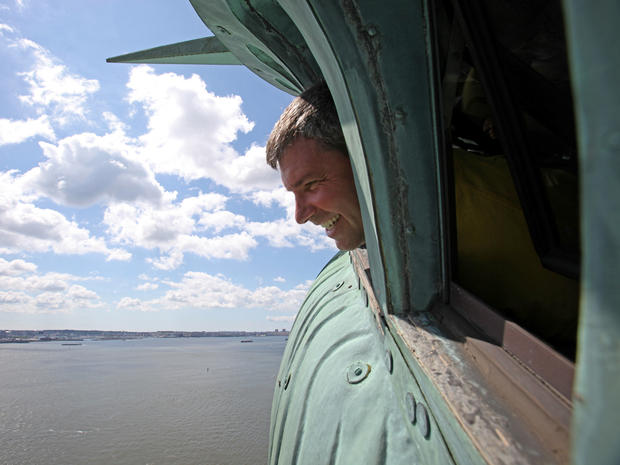 Frederick Sciulli, of Norfolk, Va., sticks his head out of a window of the crown of the Statue of Liberty July 4, 2009, in New York City. The crown, which was closed to the public after the Sept. 11, 2001, terrorist attacks, was opened again on Independen 