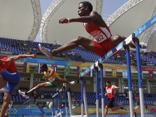 Carlos Rafael competes in the men's 110m hurdles 