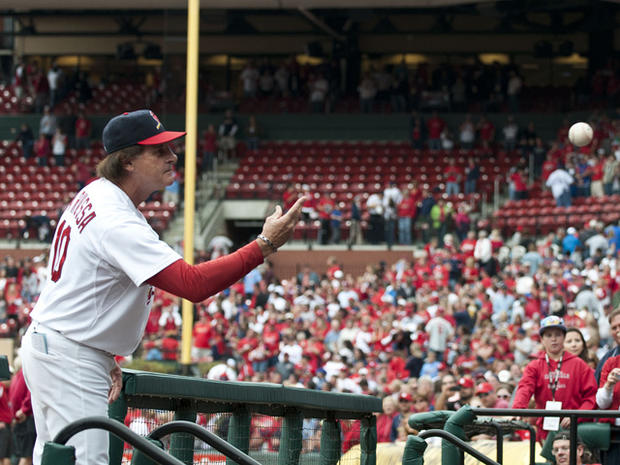 Tony LaRussa throws a ball to a fan 