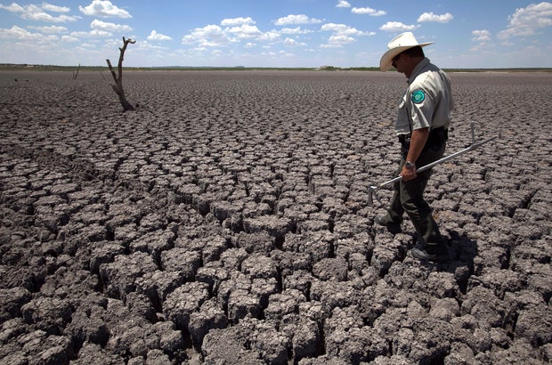 Thomas Bigham walks across the cracked lake bed 