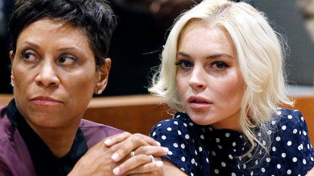 Lindsay Lohan and attorney Shawn Chapman Holley sit in court during Lohan's probation violation hearing Nov. 2, 2011, in Los Angeles. Lohan was sentenced to 300 days in jail to start Nov. 9, 2011, for violating her probation but will only serve 30 days if 