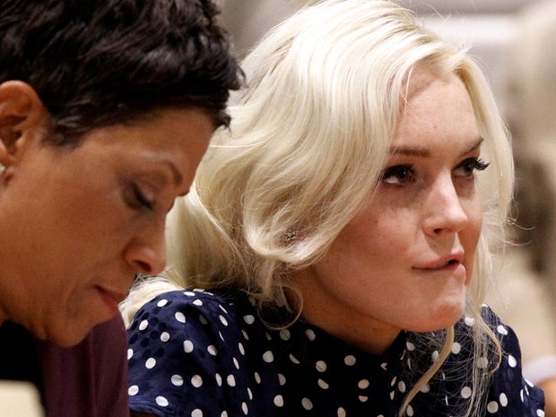 Actress Lindsay Lohan, right, bites her lip as she appears with her attorney Shawn Chapman Holley at a probation hearing in Los Angeles Superior Court Nov. 2, 2011. Judge Stephanie Sautner sentenced Lohan to 30 days in jail and warned the actress there would be plenty more time behind bars if she violated further court orders. The actress has until Nov. 9, 2011, to report for her jail term, and Sautner ruled she cannot serve house arrest, as she did previously. 