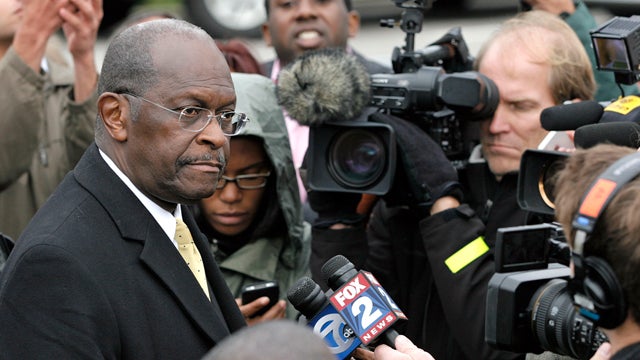 	DETROIT, MI - OCTOBER 21: Republican presidential candidate Herman Cain speaks with the news media after unveiling his 'Opportunity Zone' economic plan in front of the Michigan Central Station, an abandoned train depot, October 21, 2011 in Detroit, Michi 