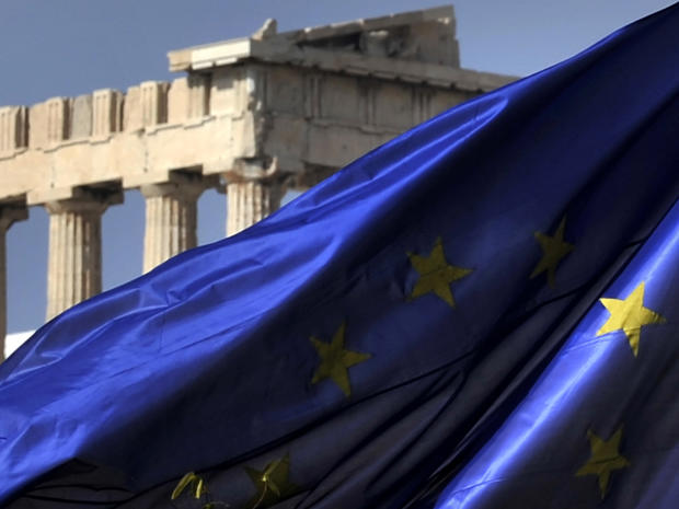 Columns of the Parthenon temple are seen behind a European Union flag in Athens, Greece, Nov. 4, 2011. 