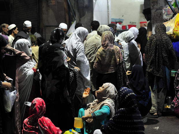 Impoverished Pakistanis line up to get free food at a restaurant in Rawalpindi Aug. 21, 2011. 