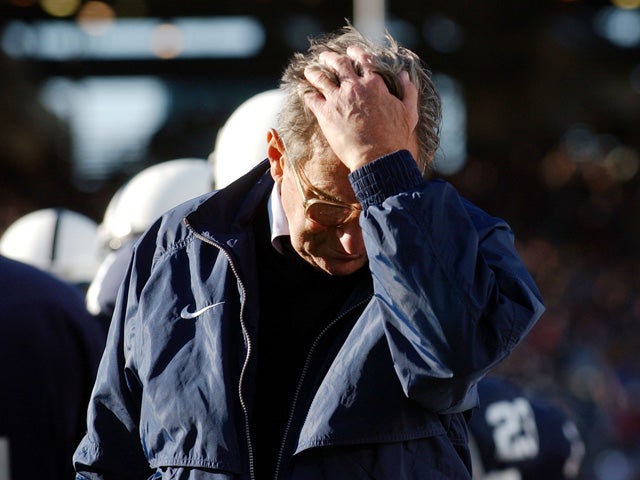 Joe Paterno pauses on the sidelines 