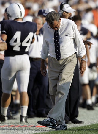 Joe Paterno kicks the turf  