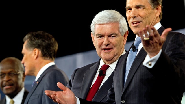 Texas Gov. Rick Perry stands with other Republican presidential hopefuls, from left to right, former restaurant executive Herman Cain, former Massachusetts Gov. Mitt Romney and former House Speaker Newt Gingrich, at the CBS News/National Journal foreign p 