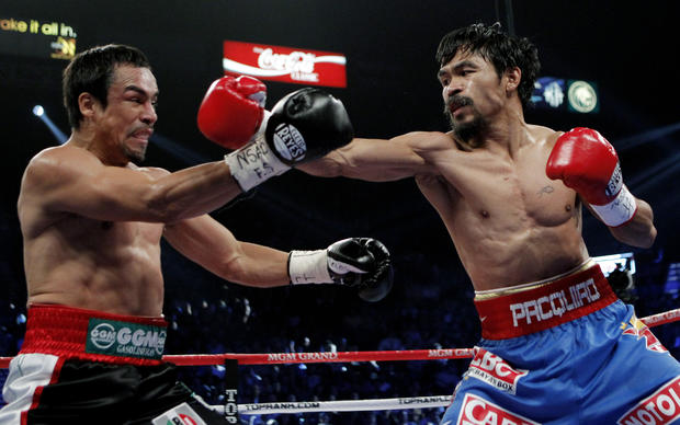 Manny Pacquiao hits Juan Manuel Marquez 