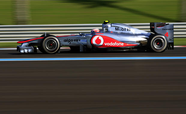 Jenson Button steers his car  