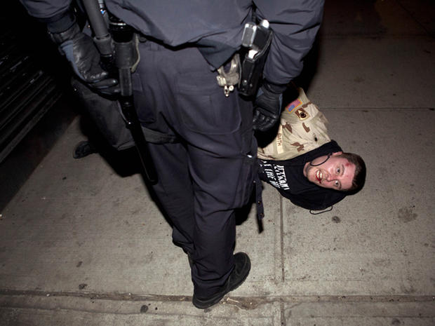  protestor is arrested on the ground by police 