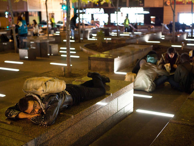 An Occupy Wall Street protestor rests in a newly tent-free Zuccotti Park 