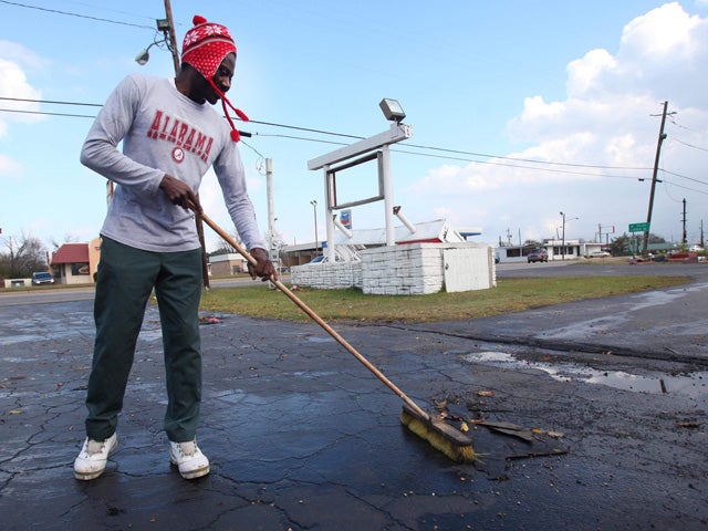 Matthew Smith cleans up debris caused by a strong storm 
