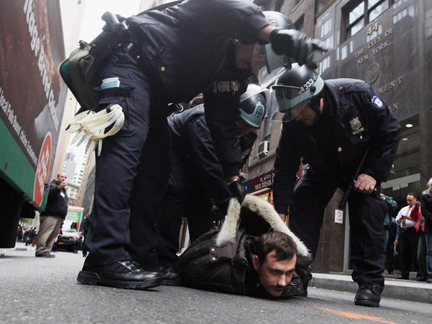 A protester affiliated with the Occupy Wall Street movement is arrested by police a few blocks from the New York Stock Exchange Nov. 17, 2011, in New York City. 