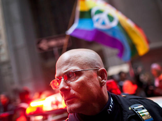 A police officer monitors protesters affiliated with the Occupy Wall Street movement as they march through New York's financial district Nov. 17, 2011. 