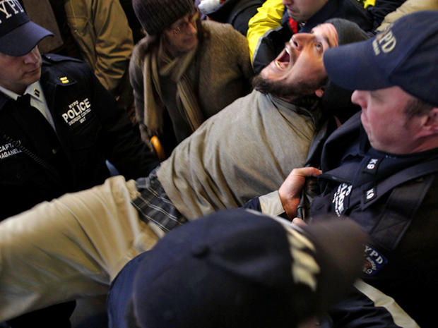 An Occupy Wall Street protester yells as he is arrested by the police after blocking an intersection near the New York Stock Exchange Nov. 17, 2011, in New York. 