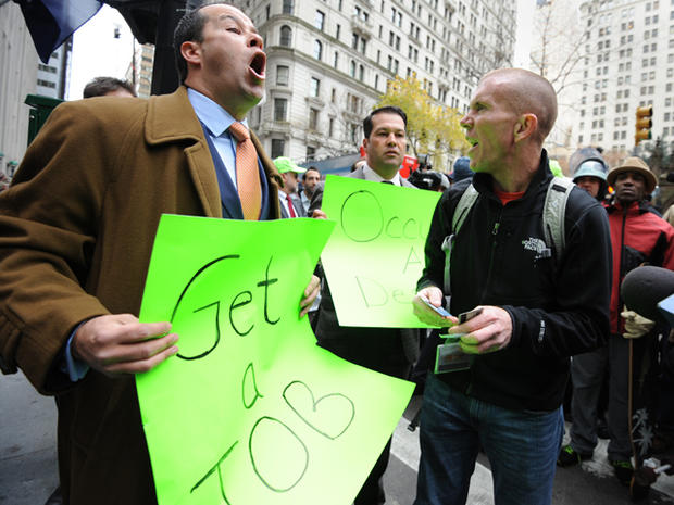 Occupy Wall Street demonstrator David Suker, right, argues with counter-demonstrator Derrick Tabacco, a small business owner, near the New York Stock Exchange as protesters mark two months since the movement's birth Nov. 17, 2011, in New York. 