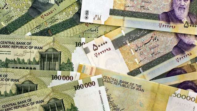 Iran's biggest denominational currencies, 100,000 Rials (then worth $8.9 U.S.) and 50,000 Rials (then worth $4.45 U.S.) are seen April 11, 2011, in Tehran, Iran. 
