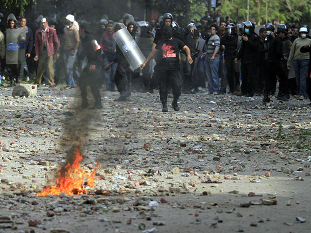 Egyptian riot police stand guard during clashes with protesters 