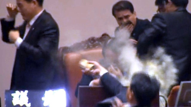 South Korean lawmake ropposed to free trade deal with U.S. douses rivals with tear gas 