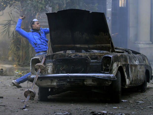 A protester throws stones during clashes with the Egyptian riot police 