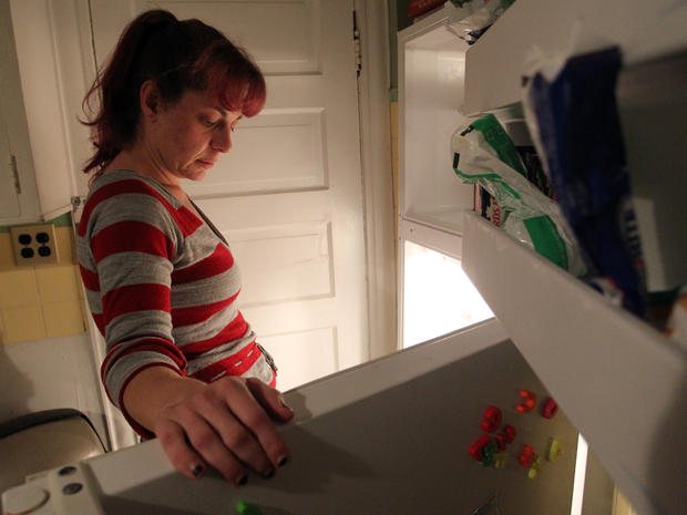 Jackie Galinis stares into her refrigerator and freezer 