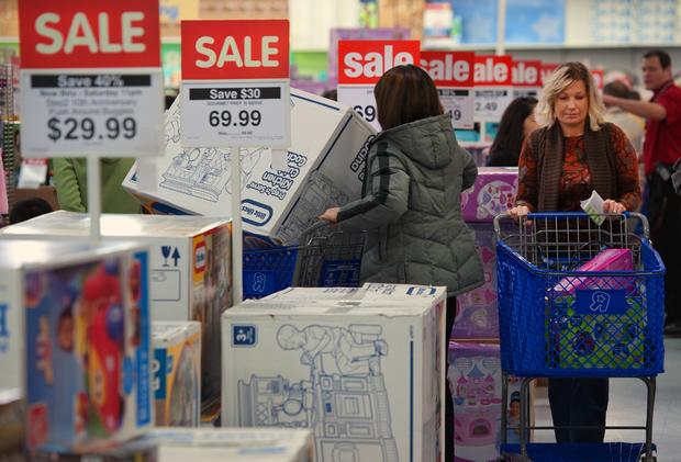 Black Friday shoppers inspect goods at a Toys-R-Us store 