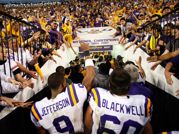Fans cheer as LSU quarterback Jordan Jefferson (9) and guard Will Blackwell (60) head into the tunnel  