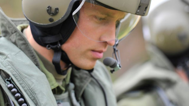 Prince William heads toward a Sea King helicopter for a training exercise. 