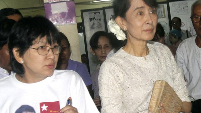 Myanmar democracy icon Aung San Suu Kyi, right, leaves her National League for Democracy (NLD) headquarters 