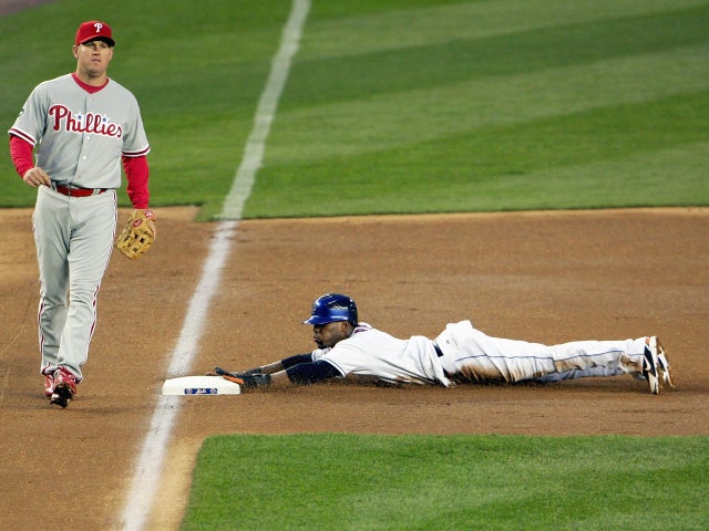 Jose Reyes slides into third base 