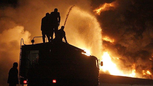 Pakistani fire fighters trying to extinguish burning NATO oil tankers after allegedly torched by militants at a terminal on the outskirts of Quetta, Pakistan on Dec. 8, 2011. 