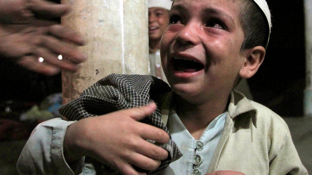 A Pakistani child weeps after being rescued by police during a raid at an Islamic seminary on the outskirts of Karachi, Pakistan, Dec. 13, 2011. Pakistani police discovered drug addicts held in chains at an Islamic seminary that offered rehabilitation ser 