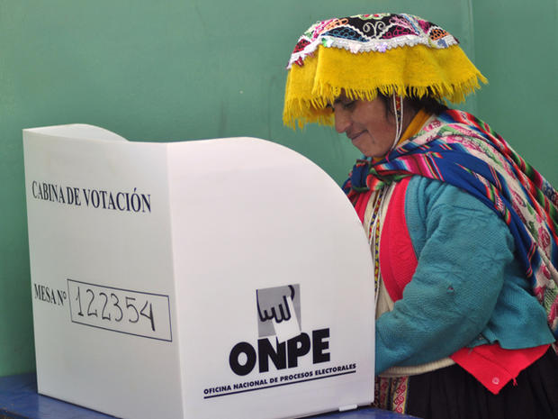 a woman votes during the Peru elections 